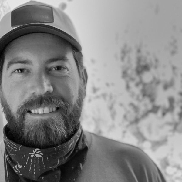 A grower in a Natural State Medicinals cap and bandana